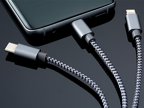 Charging cable to smartphone Close-up of mobile phone on charging cable