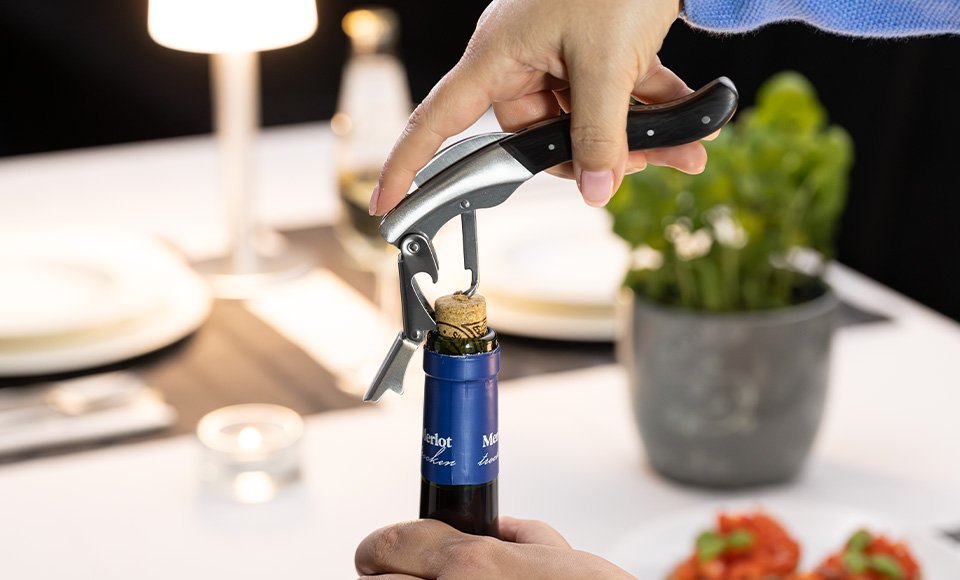 RE98 waiter's corkscrew with double lever opens a wine bottle
