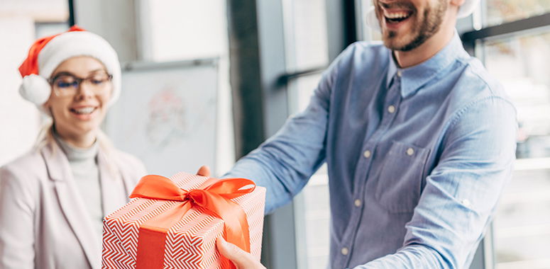 weihnachtliche Geschenkuebergabe im Buero